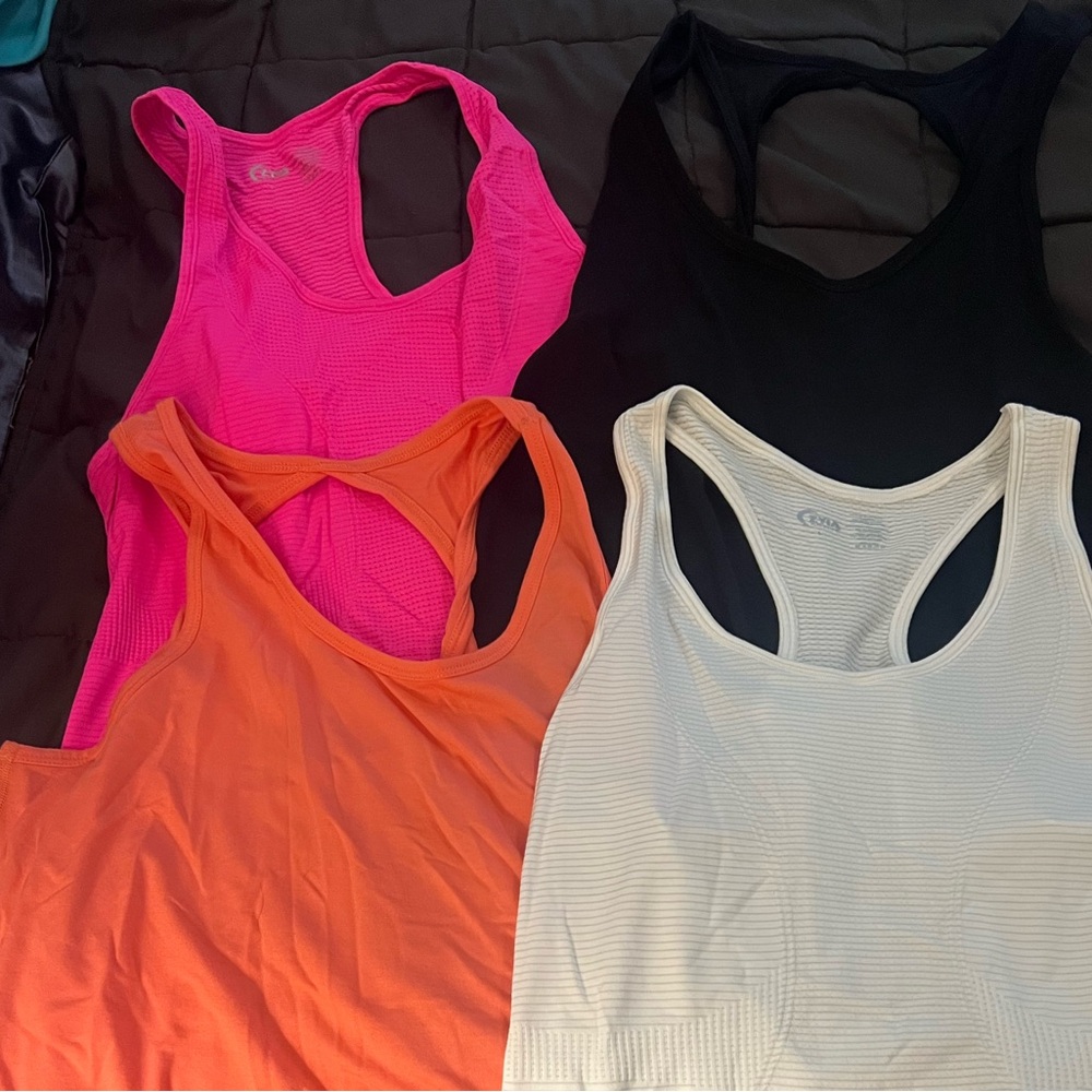 Lot of four L Zyia workout tank tops.